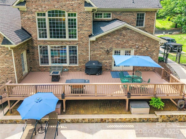 1868 Chestnut Hill Dr, Tega Cay, SC 29708 - back of property featuring a wooden deck, outdoor dining area, brick siding, and roof with shingles