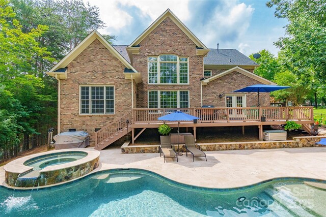 1868 Chestnut Hill Dr, Tega Cay, SC 29708 - rear view of property featuring a wooden deck, brick siding, a patio area, and a pool with connected hot tub