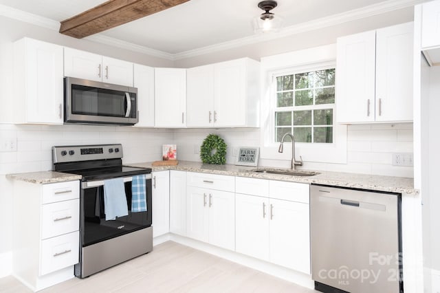 113 Elwood St, Kannapolis, NC 28081 - kitchen featuring stainless steel appliances, a sink, white cabinetry, light stone countertops, and ornamental molding