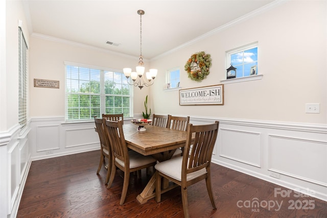 1663 Tranquility Blvd, Lancaster, SC 29720 - dining space with a chandelier, dark wood-type flooring, a decorative wall, ornamental molding, and wainscoting