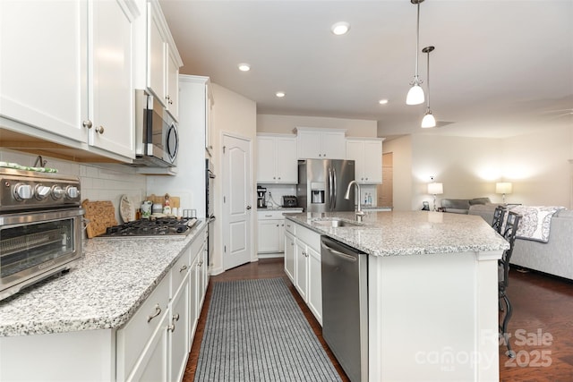 1663 Tranquility Blvd, Lancaster, SC 29720 - kitchen featuring stainless steel appliances, a sink, dark wood finished floors, tasteful backsplash, and recessed lighting