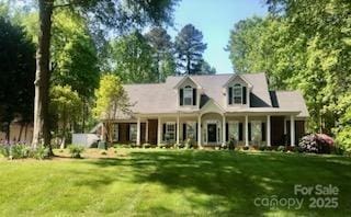 390 Robinson Rd, Mooresville, NC 28117 - cape cod-style house featuring a front yard and covered porch