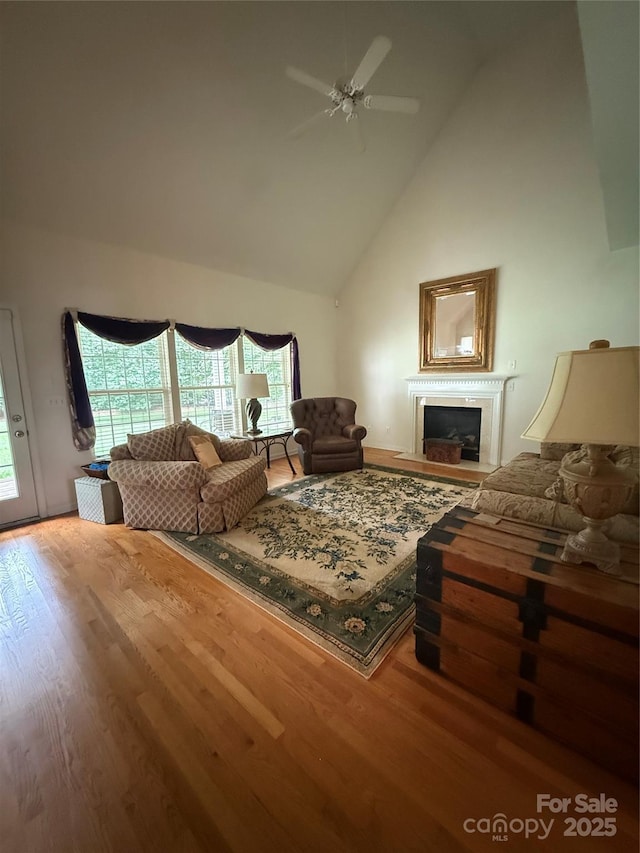 390 Robinson Rd, Mooresville, NC 28117 - living room with high vaulted ceiling, ceiling fan, wood finished floors, and a fireplace