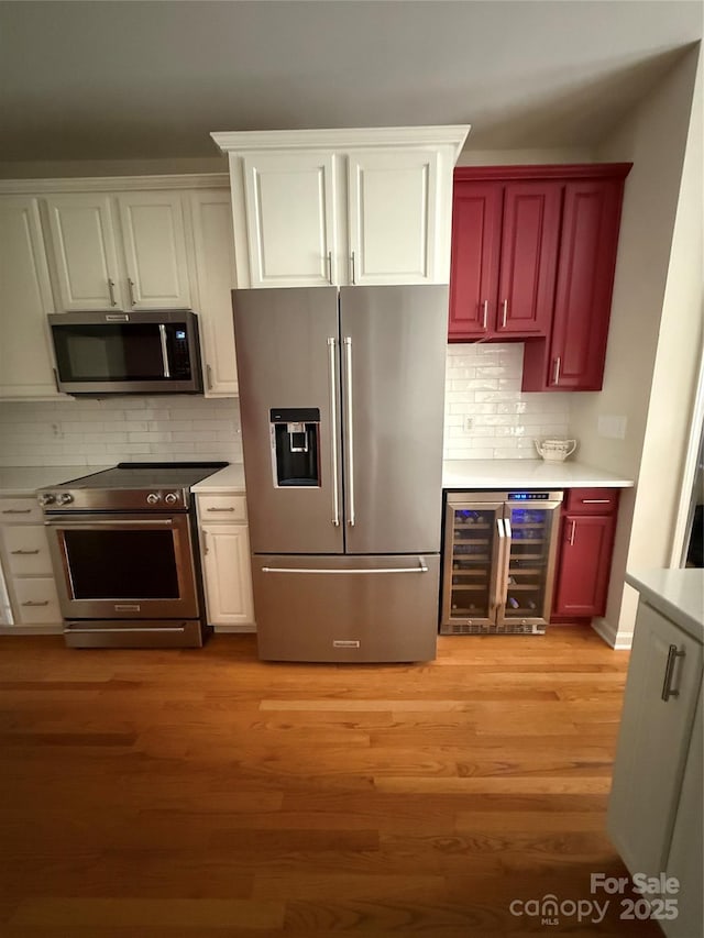 390 Robinson Rd, Mooresville, NC 28117 - kitchen with stainless steel appliances, beverage cooler, decorative backsplash, and light wood-style flooring
