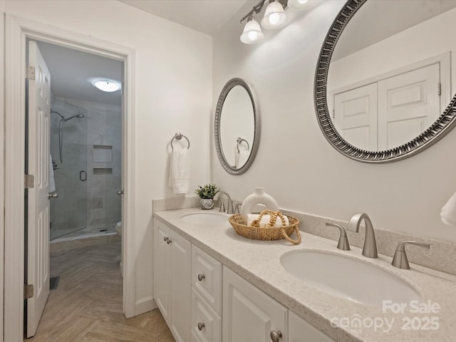 416 Queens Rd Unit 10, Charlotte, NC 28207 - bathroom with a stall shower, double vanity, and toilet