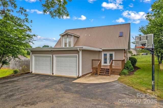 296 Hicks Creek Rd, Troutman, NC 28166 - view of front of house featuring french doors, a wooden deck, driveway, metal roof, and a garage