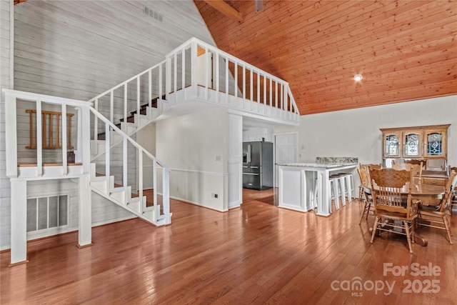 296 Hicks Creek Rd, Troutman, NC 28166 - living room featuring high vaulted ceiling, stairway, wood ceiling, and wood-type flooring