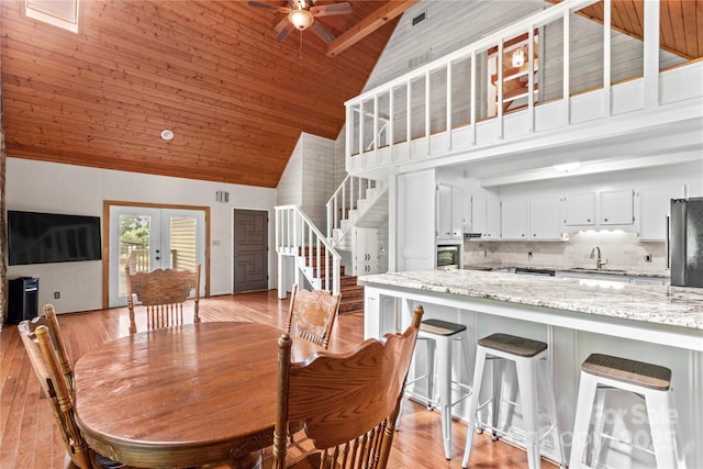 296 Hicks Creek Rd, Troutman, NC 28166 - dining room featuring wooden ceiling, high vaulted ceiling, ceiling fan, stairway, and light wood-type flooring