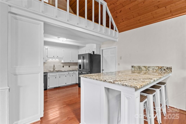 296 Hicks Creek Rd, Troutman, NC 28166 - kitchen with a sink, fridge with ice dispenser, a peninsula, wood ceiling, and vaulted ceiling