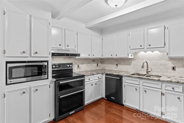 296 Hicks Creek Rd, Troutman, NC 28166 - kitchen featuring dishwashing machine, stainless steel microwave, double oven range, under cabinet range hood, and beam ceiling