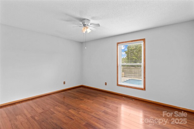 296 Hicks Creek Rd, Troutman, NC 28166 - empty room with ceiling fan, wood finished floors, baseboards, and a textured ceiling
