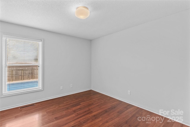 296 Hicks Creek Rd, Troutman, NC 28166 - spare room featuring wood finished floors, a textured ceiling, and baseboards