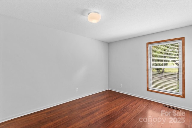 296 Hicks Creek Rd, Troutman, NC 28166 - empty room featuring dark wood-style flooring, baseboards, and a textured ceiling