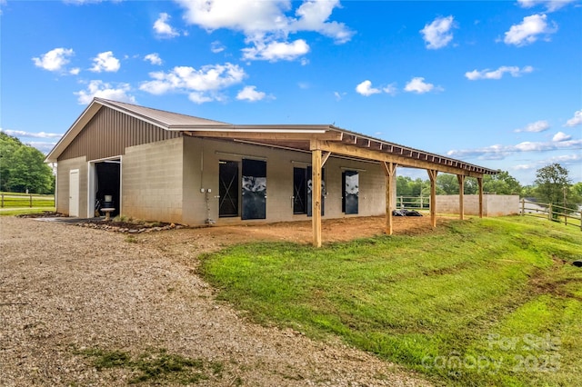 296 Hicks Creek Rd, Troutman, NC 28166 - back of property with concrete block siding, an exterior structure, an outdoor structure, and metal roof
