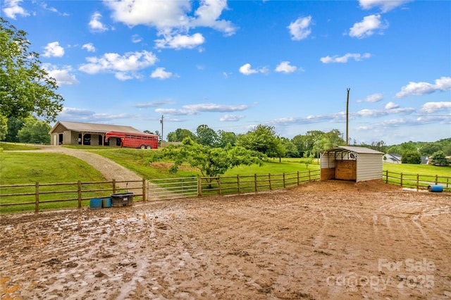296 Hicks Creek Rd, Troutman, NC 28166 - view of yard with an exterior structure, an outdoor structure, a carport, dirt driveway, and a view of countryside