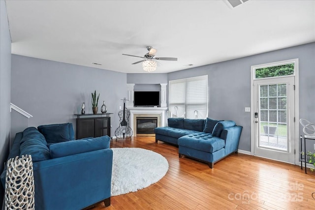 13528 Philip Michael Rd, Huntersville, NC 28078 - living room featuring a glass covered fireplace, a ceiling fan, and light wood-style floors