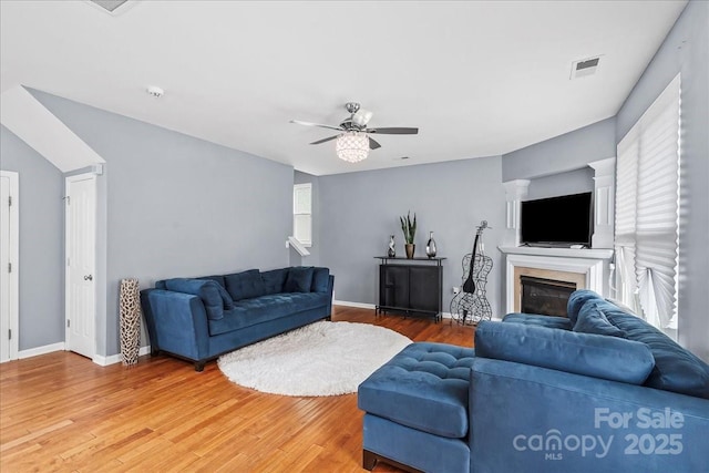 13528 Philip Michael Rd, Huntersville, NC 28078 - living room featuring a ceiling fan, light wood finished floors, and a glass covered fireplace