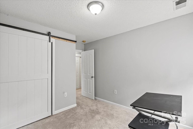 13528 Philip Michael Rd, Huntersville, NC 28078 - bedroom featuring carpet, a barn door, and a textured ceiling