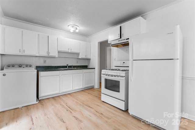 2328 Danforth Ln, Charlotte, NC 28208 - kitchen featuring white appliances, washer / clothes dryer, a sink, under cabinet range hood, and white cabinetry