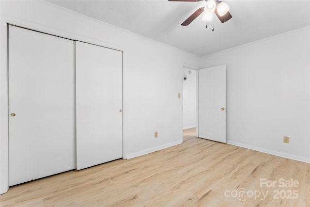2328 Danforth Ln, Charlotte, NC 28208 - unfurnished bedroom featuring ornamental molding, wood finished floors, a closet, a ceiling fan, and baseboards