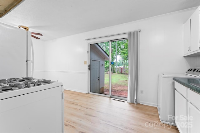 2328 Danforth Ln, Charlotte, NC 28208 - kitchen with washer / dryer, white appliances, white cabinets, and light wood-style floors