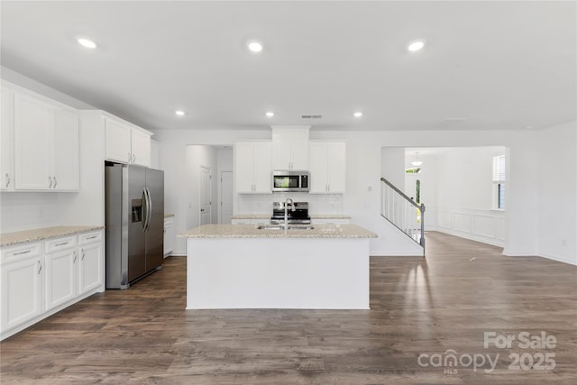 15208 Caspian Way, Charlotte, NC 28278 - kitchen featuring appliances with stainless steel finishes, a sink, white cabinetry, an island with sink, and dark wood-style floors