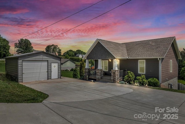 39 Curtis Miles Rd, Alexander, NC 28701 - view of front of house with a detached garage, covered porch, an outbuilding, a shingled roof, and driveway