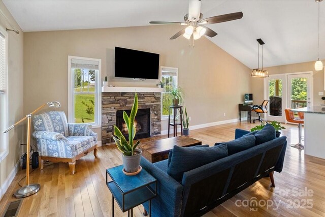 39 Curtis Miles Rd, Alexander, NC 28701 - living room featuring vaulted ceiling, a fireplace, wood finished floors, ceiling fan, and baseboards