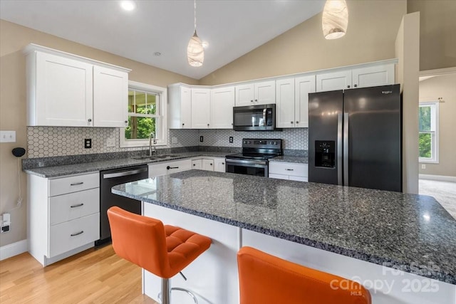 39 Curtis Miles Rd, Alexander, NC 28701 - kitchen featuring appliances with stainless steel finishes, a sink, white cabinets, light wood-style floors, and backsplash