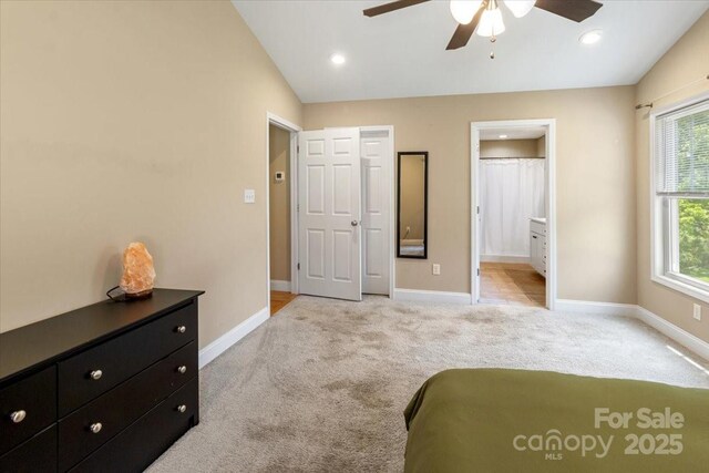 39 Curtis Miles Rd, Alexander, NC 28701 - bedroom featuring vaulted ceiling, light colored carpet, baseboards, connected bathroom, and a ceiling fan