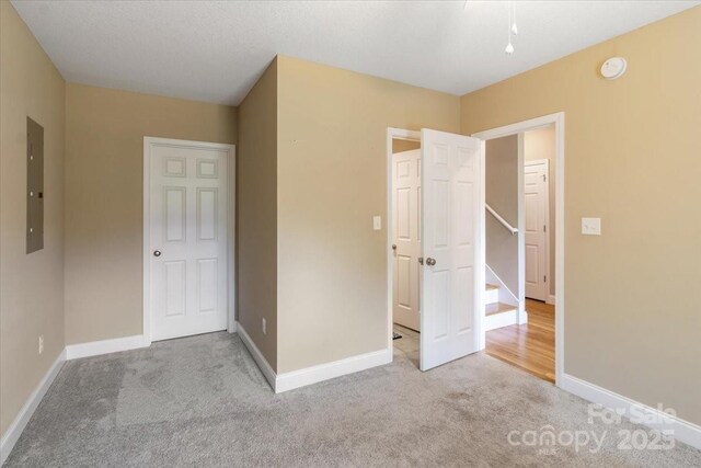 39 Curtis Miles Rd, Alexander, NC 28701 - unfurnished bedroom featuring carpet floors, electric panel, and baseboards