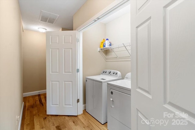 39 Curtis Miles Rd, Alexander, NC 28701 - laundry area featuring independent washer and dryer, light wood-style flooring, and baseboards