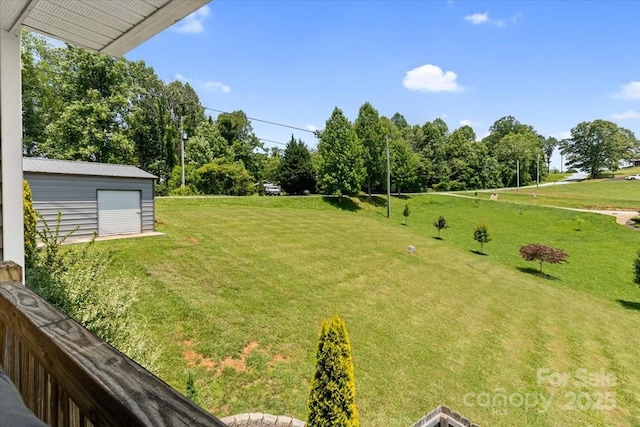 39 Curtis Miles Rd, Alexander, NC 28701 - view of grassy yard featuring a detached garage, view of wooded area, and an outbuilding