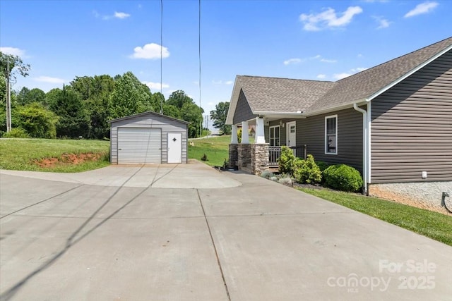 39 Curtis Miles Rd, Alexander, NC 28701 - view of side of home featuring an outdoor structure, a detached garage, a porch, a shingled roof, and a lawn