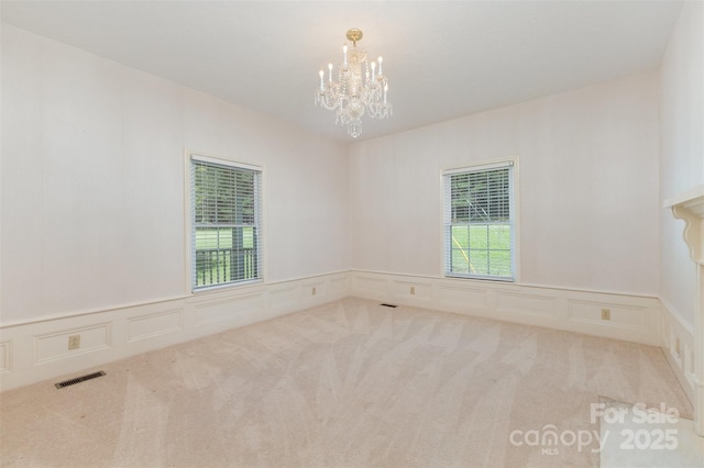 130 Merton Rd, Lawndale, NC 28090 - carpeted empty room with a chandelier, plenty of natural light, a decorative wall, and wainscoting