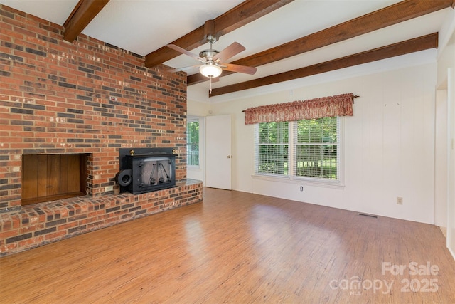 130 Merton Rd, Lawndale, NC 28090 - unfurnished living room featuring wood finished floors, beamed ceiling, and a ceiling fan