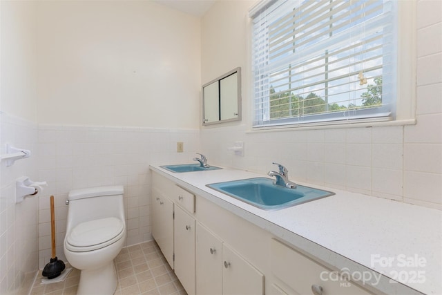 130 Merton Rd, Lawndale, NC 28090 - bathroom featuring double vanity, tile patterned floors, toilet, a wainscoted wall, and tile walls