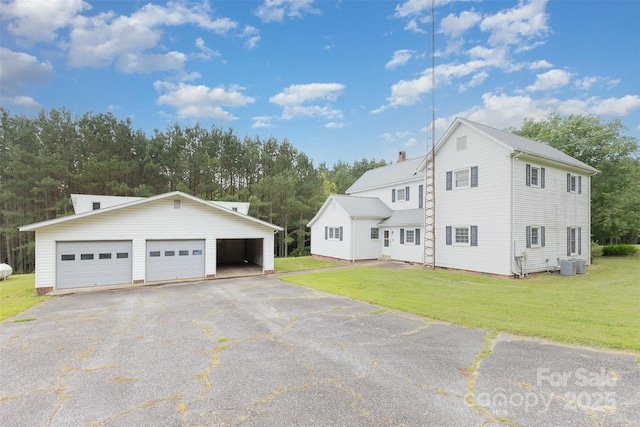 130 Merton Rd, Lawndale, NC 28090 - view of property exterior with central air condition unit, an outbuilding, a garage, a lawn, and a chimney