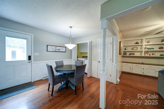734 Forestbrook Dr, Gastonia, NC 28056 - dining space with a textured ceiling, wainscoting, dark wood finished floors, washing machine and clothes dryer, and a ceiling fan