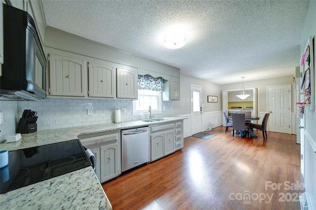 734 Forestbrook Dr, Gastonia, NC 28056 - kitchen with dishwasher, a textured ceiling, decorative backsplash, wood finished floors, and decorative light fixtures