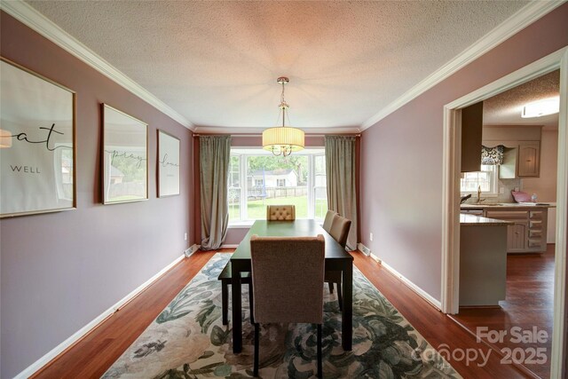 734 Forestbrook Dr, Gastonia, NC 28056 - dining space featuring a textured ceiling, dark wood finished floors, and crown molding