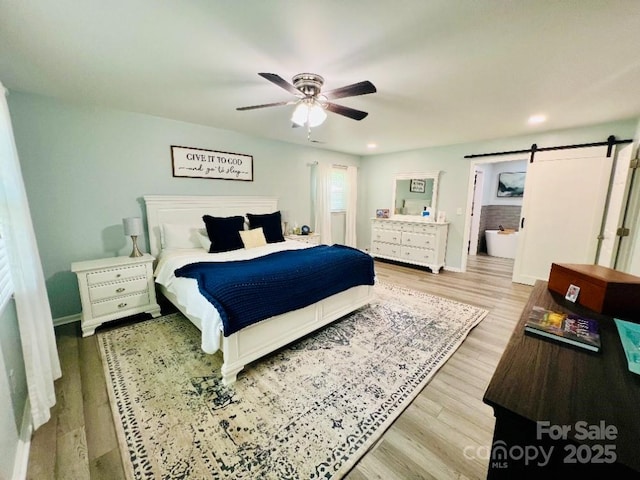 734 Forestbrook Dr, Gastonia, NC 28056 - bedroom with a barn door, wood finished floors, a ceiling fan, and recessed lighting