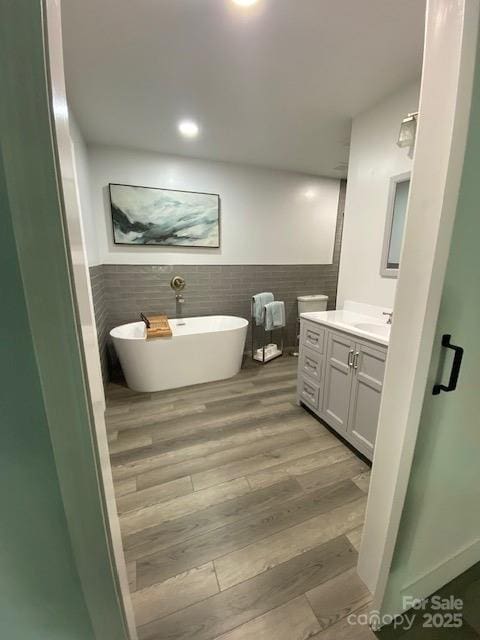 734 Forestbrook Dr, Gastonia, NC 28056 - full bathroom featuring vanity, a freestanding bath, wainscoting, and tile walls