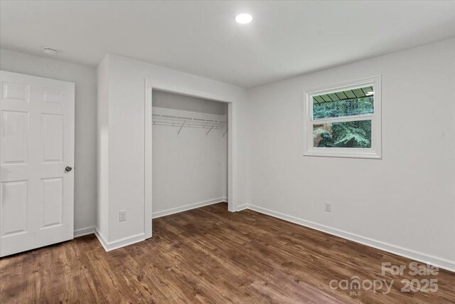 704 W Border St, Dallas, NC 28034 - unfurnished bedroom with baseboards, dark wood-style flooring, and a closet