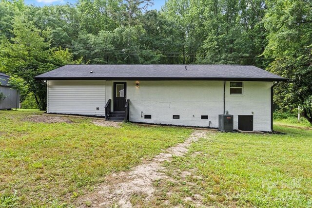 704 W Border St, Dallas, NC 28034 - back of property featuring entry steps, crawl space, a lawn, central air condition unit, and brick siding