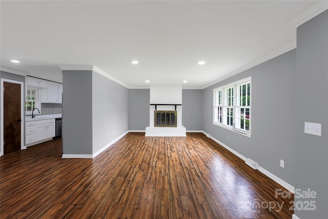 106 Edith Dr, Mauldin, SC 29662 - unfurnished living room with a sink, dark wood finished floors, ornamental molding, baseboards, and recessed lighting