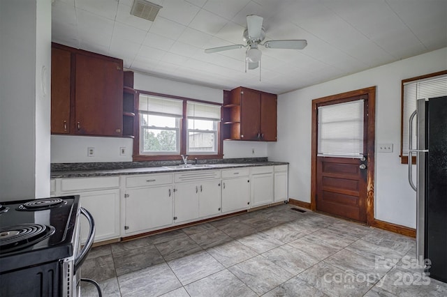 843 Summers Rd, Valdese, NC 28690 - kitchen with open shelves, black electric range, freestanding refrigerator, a ceiling fan, and white cabinetry