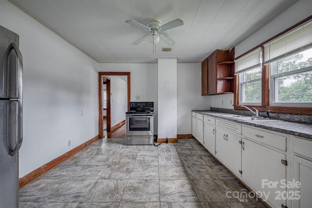 843 Summers Rd, Valdese, NC 28690 - kitchen with appliances with stainless steel finishes, open shelves, ceiling fan, dark countertops, and white cabinetry