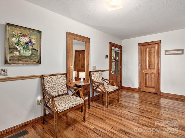 505 Middle Top Loop, Maggie Valley, NC 28751 - sitting room featuring light wood finished floors, a textured ceiling, and baseboards