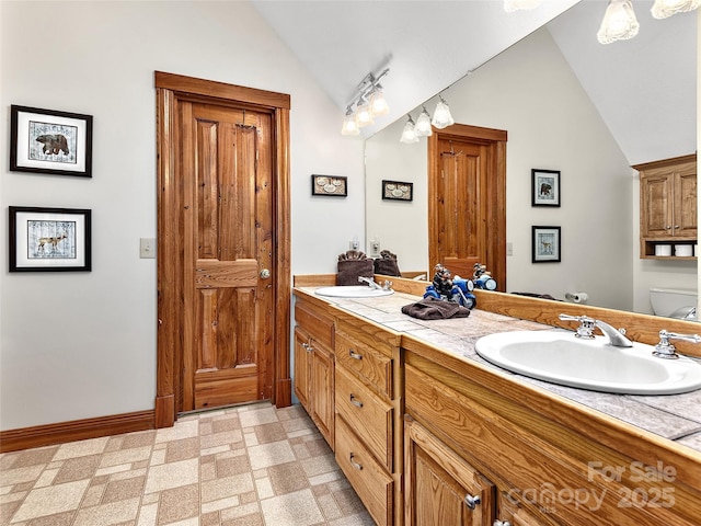505 Middle Top Loop, Maggie Valley, NC 28751 - bathroom with vaulted ceiling, double vanity, toilet, and baseboards